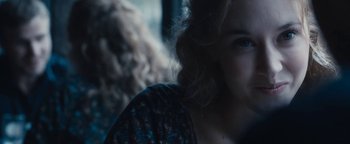 A woman's face with curly brown hair
