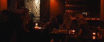 Movie still from “Simon Killer” (2012), directed by Antonio Campos – Two women sitting at a table in front of candles; Wide shot, Over the shoulder angle