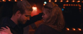 Movie still from “Simon Killer” (2012), directed by Antonio Campos – A man and a woman standing next to each other; Close Up shot, Over the shoulder angle