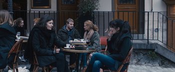 Movie still from “Simon Killer” (2012), directed by Antonio Campos – A group of people sitting around a table; Medium shot, Over the shoulder angle