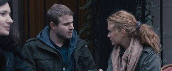 Movie still from “Simon Killer” (2012), directed by Antonio Campos – A man and a woman talking to each other outside; Close Up shot, Over the shoulder angle