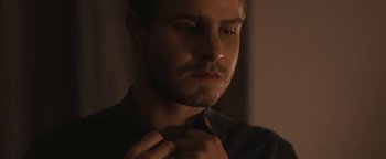Movie still from “Simon Killer” (2012), directed by Antonio Campos – A person tying a tie; Close Up shot, Over the shoulder angle