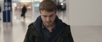 Movie still from “Simon Killer” (2012), directed by Antonio Campos – A person wearing a jacket; Close Up shot, Over the shoulder angle