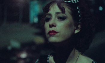 Movie still from “Smithereens” (1982), directed by Susan Seidelman – A person wearing a headband; Close Up shot, Low angle