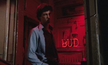 Movie still from “Smithereens” (1982), directed by Susan Seidelman – A man standing in front of a neon bud sign; Close Up shot, Low angle