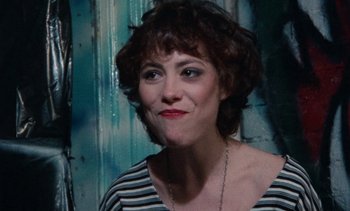 Movie still from “Smithereens” (1982), directed by Susan Seidelman – A person wearing a striped shirt; Close Up shot, Over the shoulder angle
