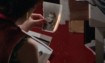 Movie still from “Smithereens” (1982), directed by Susan Seidelman – A person holding a picture of a young girl; Extreme Close Up shot, Over the shoulder angle