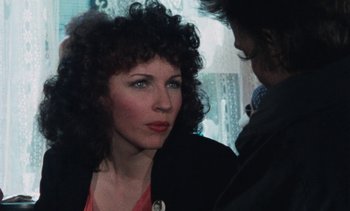Movie still from “Smithereens” (1982), directed by Susan Seidelman – A person with curly hair; Close Up shot, Over the shoulder angle