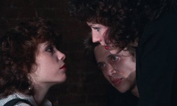 Movie still from “Smithereens” (1982), directed by Susan Seidelman – A man and a woman looking at each other; Close Up shot, Over the shoulder angle