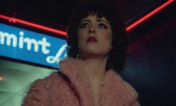 Movie still from “Smithereens” (1982), directed by Susan Seidelman – A person wearing a pink coat; Close Up shot, Low angle