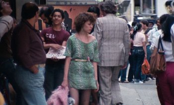 Movie still from “Smithereens” (1982), directed by Susan Seidelman – A group of people standing on the sidewalk; Medium shot, High angle