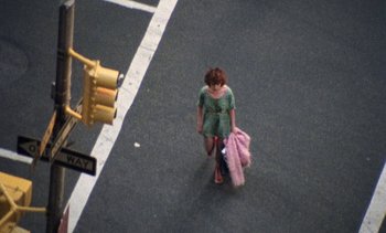 Movie still from “Smithereens” (1982), directed by Susan Seidelman – A little girl walking down the street with a pink bag; Wide shot, High angle