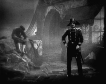 Movie still from “Street Angel” (1928), directed by Frank Borzage – An old photo of a man in a uniform and a hat; Wide shot, High angle