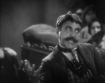 Movie still from “Street Angel” (1928), directed by Frank Borzage – An older man with a mustache wearing a hat; Close Up shot, Low angle