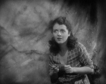Movie still from “Street Angel” (1928), directed by Frank Borzage – An old photo of a woman holding a camera; Close Up shot, High angle
