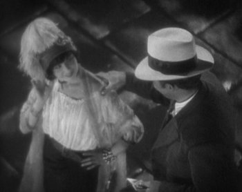 Movie still from “Street Angel” (1928), directed by Frank Borzage – A man and a woman in a hat and dress; Medium shot, High angle