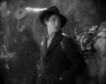 Movie still from “Street Angel” (1928), directed by Frank Borzage – A black and white photo of a man wearing a hat; Medium shot, High angle