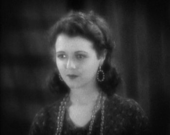 Movie still from “Street Angel” (1928), directed by Frank Borzage – An old photo of a young woman in a black dress; Close Up shot, High angle