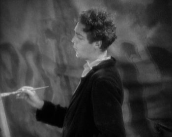 Movie still from “Street Angel” (1928), directed by Frank Borzage – A black and white photo of a man holding a paintbrush; Medium shot, High angle
