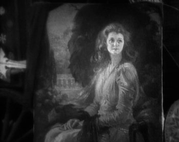 Movie still from “Street Angel” (1928), directed by Frank Borzage – An old painting of a young woman sitting in a chair; Close Up shot, High angle