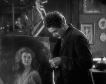 Movie still from “Street Angel” (1928), directed by Frank Borzage – A black and white photo of a man painting a woman; Medium shot, Over the shoulder angle