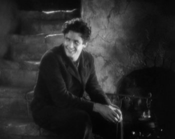 Movie still from “Street Angel” (1928), directed by Frank Borzage – An old photo of a woman sitting in a chair; Medium shot, High angle