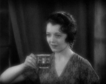 Movie still from “Street Angel” (1928), directed by Frank Borzage – An old photo of a woman holding a cup; Close Up shot, High angle