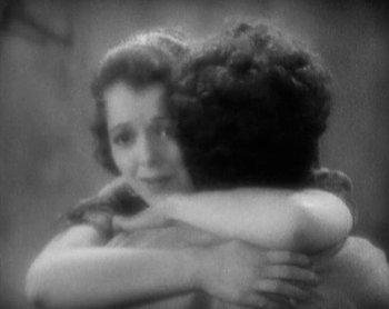 Movie still from “Street Angel” (1928), directed by Frank Borzage – A woman hugging another woman in a black and white photo; Close Up shot, Low angle