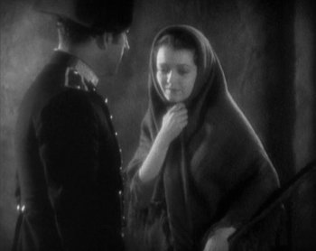 Movie still from “Street Angel” (1928), directed by Frank Borzage – A man and a woman standing next to each other; Medium shot, High angle