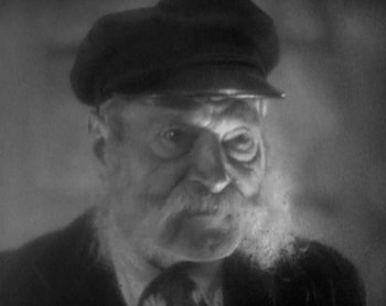 Movie still from “Street Angel” (1928), directed by Frank Borzage – An old man wearing a hat and a tie; Close Up shot, Low angle