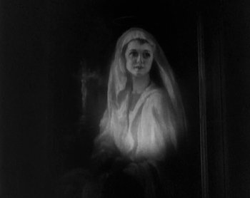 Movie still from “Street Angel” (1928), directed by Frank Borzage – A woman with a veil is standing in a dark room; Close Up shot, Low angle