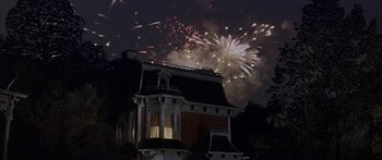 Movie still from “Summer and Smoke” (1961), directed by Peter Glenville – A house with a bunch of fireworks in the background; Extreme Wide shot, Low angle