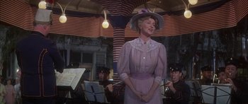 Movie still from “Summer and Smoke” (1961), directed by Peter Glenville – An older woman wearing a purple dress and a purple hat; Medium shot, Low angle