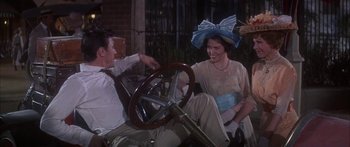 Movie still from “Summer and Smoke” (1961), directed by Peter Glenville – A man and a woman sitting in a car with a steering wheel; Medium shot, Over the shoulder angle