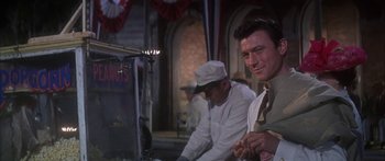 Movie still from “Summer and Smoke” (1961), directed by Peter Glenville – Two men in white shirts and ties sitting next to each other in a room; Medium shot, Over the shoulder angle