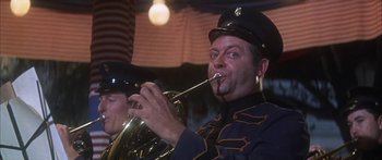 Movie still from “Summer and Smoke” (1961), directed by Peter Glenville – A man in a uniform playing a trombone; Close Up shot, Low angle