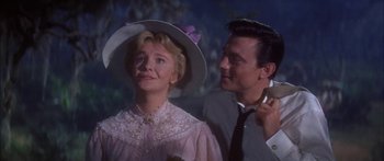 Movie still from “Summer and Smoke” (1961), directed by Peter Glenville – An older woman in a hat and a young man in a suit; Close Up shot, Low angle