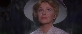 Movie still from “Summer and Smoke” (1961), directed by Peter Glenville – An older woman wearing a white hat looking upward; Close Up shot, Low angle