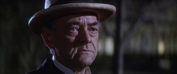 Movie still from “Summer and Smoke” (1961), directed by Peter Glenville – An older man wearing a straw hat and a suit; Close Up shot, Low angle