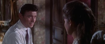 Movie still from “Summer and Smoke” (1961), directed by Peter Glenville – A man talking to another man in front of a door; Close Up shot, Over the shoulder angle