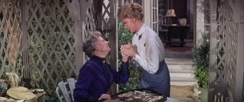 Movie still from “Summer and Smoke” (1961), directed by Peter Glenville – A woman and an older woman holding their hands together; Medium shot, High angle