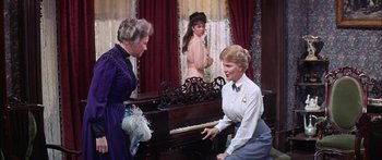 Movie still from “Summer and Smoke” (1961), directed by Peter Glenville – Two women and a man are playing a piano; Medium shot, Over the shoulder angle