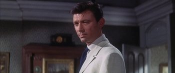 Movie still from “Summer and Smoke” (1961), directed by Peter Glenville – A person wearing a suit and tie; Close Up shot, Low angle