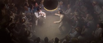 Movie still from “Summer and Smoke” (1961), directed by Peter Glenville – A group of people sitting in a circle with a man in the middle of the circle; Wide shot, Overhead angle