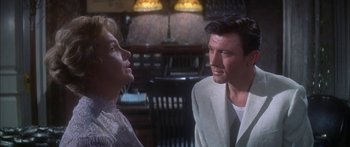 Movie still from “Summer and Smoke” (1961), directed by Peter Glenville – A man and a woman talking to each other in a room; Medium shot, Over the shoulder angle