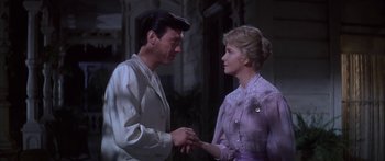 Movie still from “Summer and Smoke” (1961), directed by Peter Glenville – A man and a woman holding hands in a room; Medium shot, Low angle