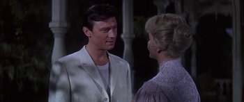 Movie still from “Summer and Smoke” (1961), directed by Peter Glenville – A man and a woman talking to each other; Medium shot, Over the shoulder angle