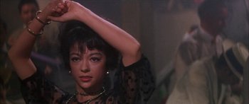 Movie still from “Summer and Smoke” (1961), directed by Peter Glenville – A person wearing a black and white dress; Close Up shot, Low angle