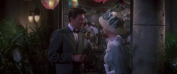 Movie still from “Summer and Smoke” (1961), directed by Peter Glenville – A man and a woman talking in front of a crowd of onlookers; Medium shot, Over the shoulder angle