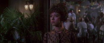 Movie still from “Summer and Smoke” (1961), directed by Peter Glenville – A woman in a polka dot dress looking to her left; Close Up shot, Over the shoulder angle